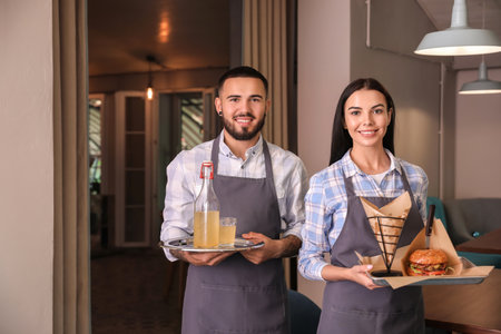 Portrait of young waiters in a restaurantの写真素材