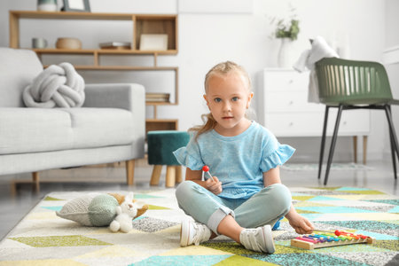 Cute little girl playing at homeの写真素材