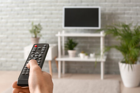 Young man watching TV at homeの写真素材