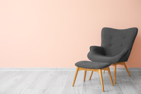 Stylish armchair near color wall in roomの写真素材