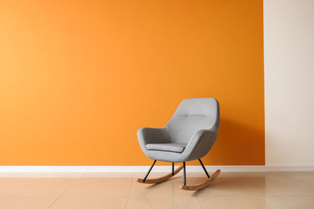 Stylish armchair near color wall in roomの写真素材