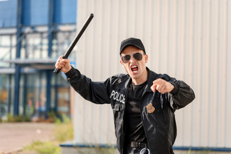 Aggressive police officer with baton outdoorsの写真素材