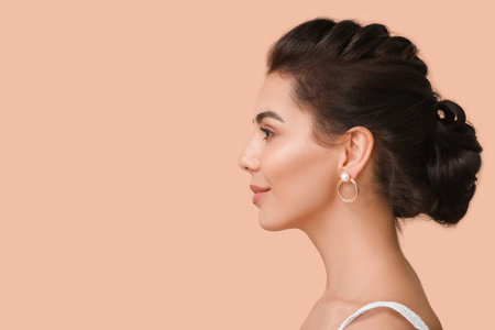 Beautiful young woman with stylish hairdo on color backgroundの写真素材