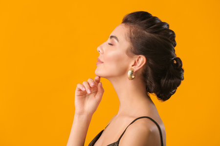 Beautiful young woman with stylish hairdo on color backgroundの写真素材