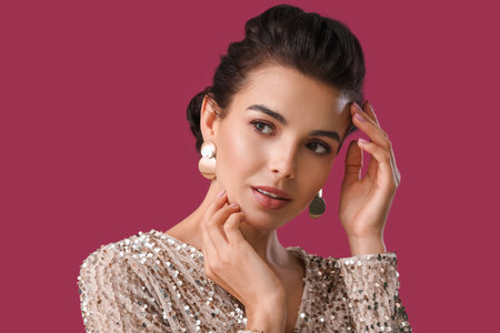 Beautiful young woman with stylish hairdo on color backgroundの写真素材