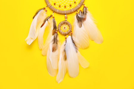 Beautiful dream catcher on yellow backgroundの写真素材