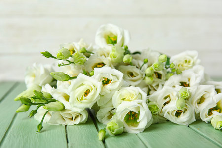 Bouquet of beautiful eustoma flowers on color wooden table, closeupの写真素材