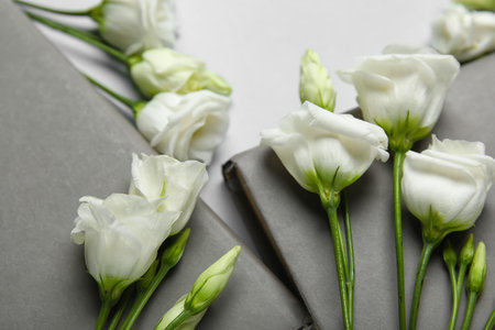 Composition with books and beautiful eustoma flowers on light background, closeupの写真素材