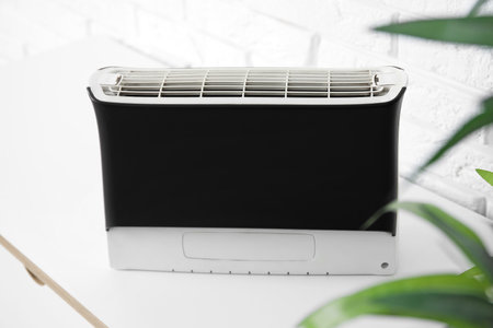Air purifier on table near white brick wall, closeupの写真素材