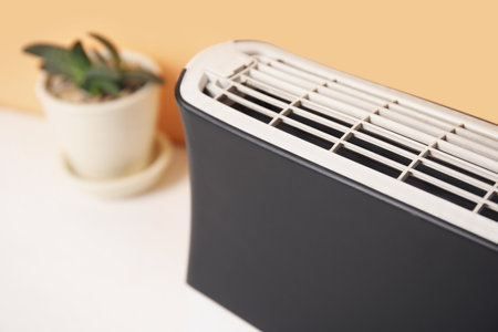 Air purifier and succulent on table near beige wall, closeupの写真素材