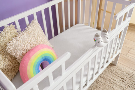 Baby crib with pillows in children's bedroomの写真素材