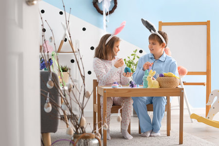 Little children with paper Easter eggs at homeの写真素材