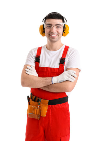 Young carpenter in hearing protectors on white background
