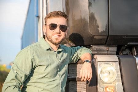 Male driver near big truck outdoors