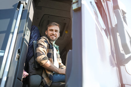 young man driving modern truckの写真素材