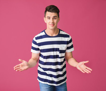 Handsome young man on color backgroundの写真素材