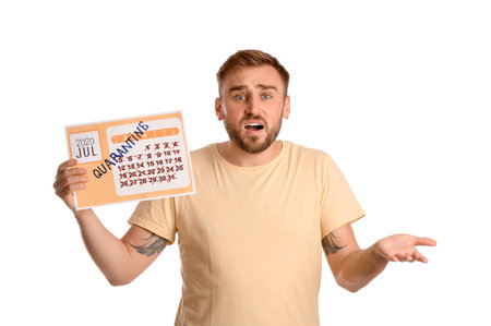 Troubled man holding calendar with written word QUARANTINE against white backgroundの写真素材