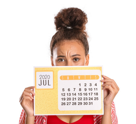 Sad woman with calendar on white background. vacation conceptの写真素材