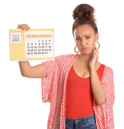 Sad woman with calendar on white background. vacation conceptの写真素材