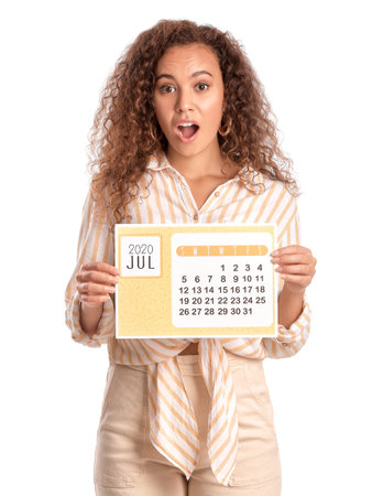 Surprised woman with calendar on white background. vacation conceptの写真素材