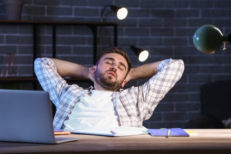 student sleeping at table late in the evening