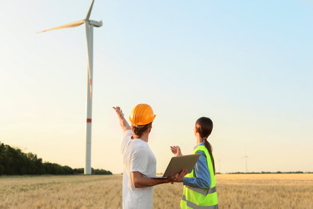 Engineers on windmill farm for electric power productionの写真素材