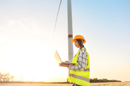 Female engineer on windmill farm for electric power productionの写真素材