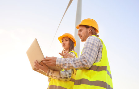 Engineers on windmill farm for electric power productionの写真素材