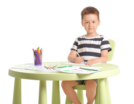 Cute little boy coloring pictures on white backgroundの写真素材