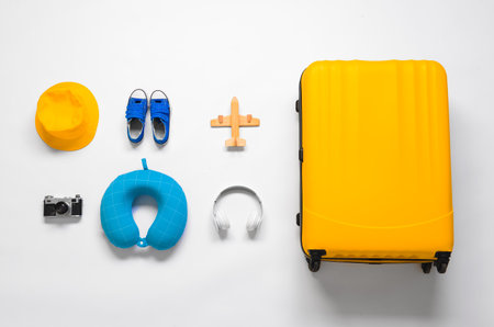 Suitcase with travel accessories for children on white backgroundの写真素材