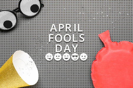 Text APRIL FOOLS DAY, funny decor and party hat on boardの写真素材