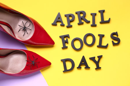 Text APRIL FOOLS DAY and heels with spiders on color backgroundの写真素材