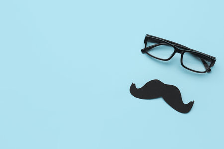 Paper mustache and eyeglasses on color backgroundの写真素材