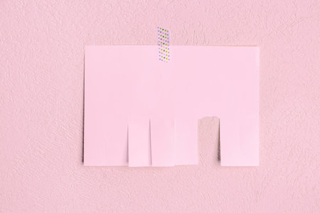 Blank paper tear-off ad on pink wallの写真素材