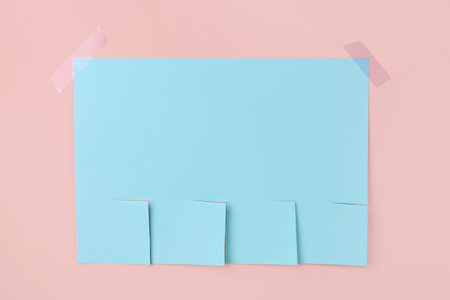 Blank paper tear-off ad on pink backgroundの写真素材