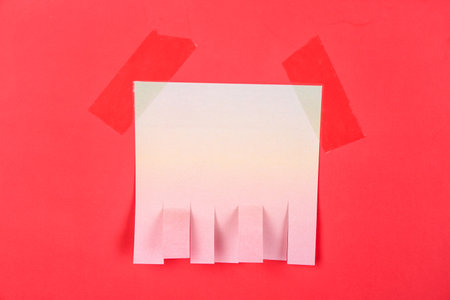 Blank paper tear-off ad on red backgroundの写真素材