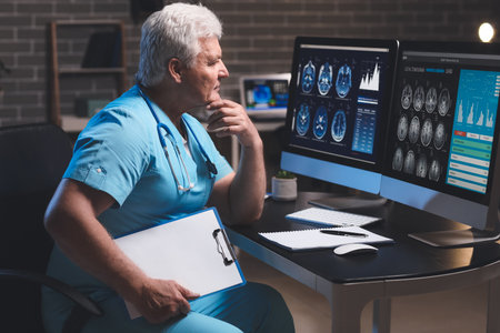 Senior neurologist with MRI scan of human head in clinicの写真素材