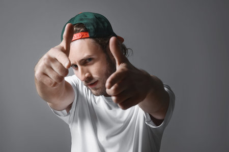 Male hip-hop dancer on gray background