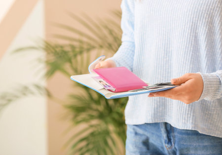 Woman with travel organizer indoorsの写真素材