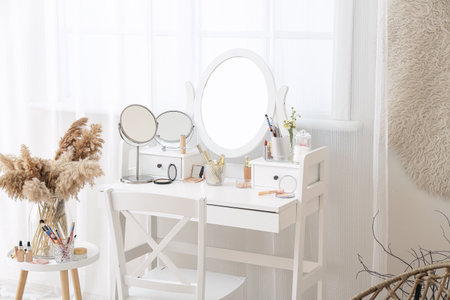 Set of decorative cosmetics on dressing table in roomの写真素材