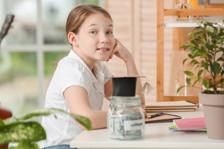 Girl with savings for education at homeの写真素材