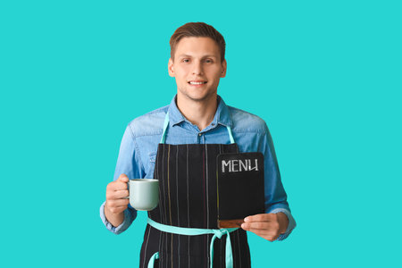 Young male barista on color backgroundの写真素材