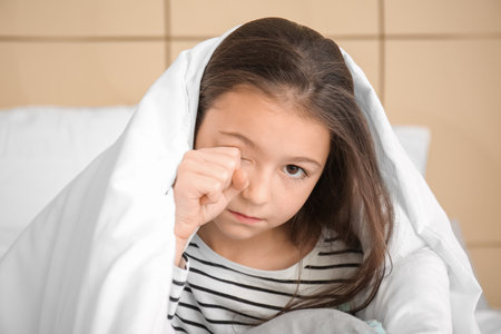 Little girl suffering from sleep disorder in the bedroomの写真素材