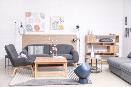 Stylish interior of living room with comfortable sofa and table