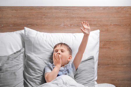 Little boy suffering from sleep disorder in the bedroomの写真素材
