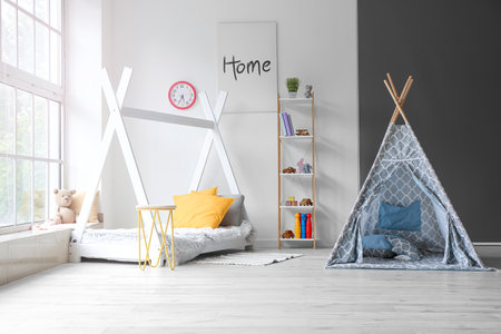 Interior of modern children's room with play tent and bedの写真素材
