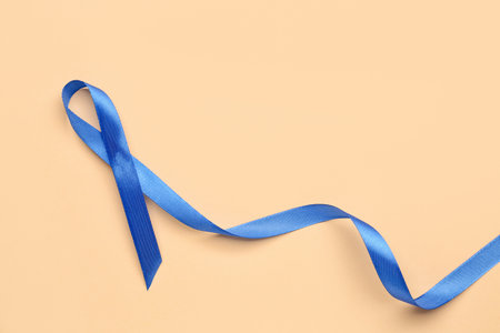 Blue awareness ribbon on color background. Prostate cancer conceptの写真素材