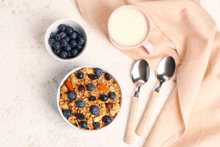 Tasty breakfast with granola on light backgroundの写真素材