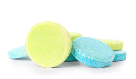 Blue and green soluble tablets isolated on white backgroundの写真素材