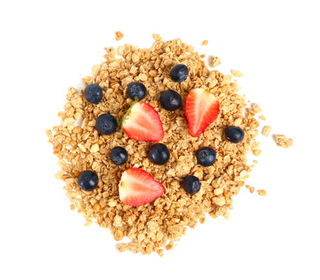 Heap of tasty granola with berries on white backgroundの写真素材